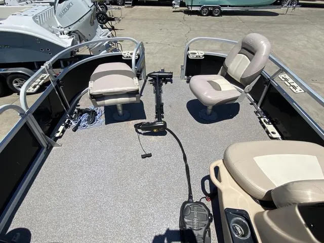 Slide: The Image of 2015 Sun Tracker 18 DLX pontoon boat interior with seating and fishing setup. - 5