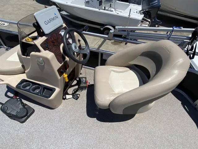 Slide: The Image of 2015 Sun Tracker 18 DLX boat interior with Garmin navigation and comfortable seating. - 7