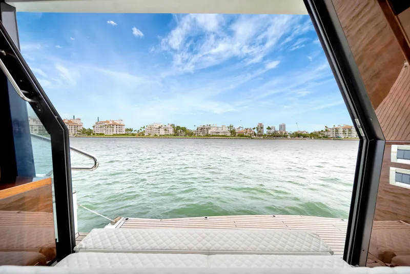 Slide: The Image of View from Galeon 500 Fly yacht, overlooking serene waters and distant cityscape under a clear sky. - 12