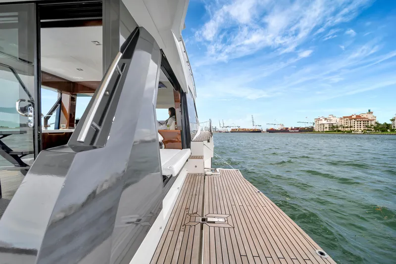 Slide: The Image of 2020 Galeon 500 Fly yacht on water with cityscape in background. - 5
