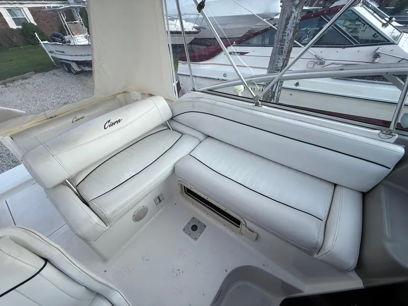 Slide: The Image of 1997 Bayliner 2655 Ciera boat interior with white cushioned seating. - 3