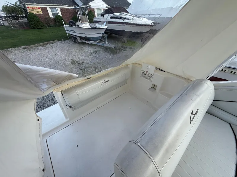 Slide: The Image of 1997 Bayliner 2655 Ciera boat interior with white seating and covered deck area. - 4
