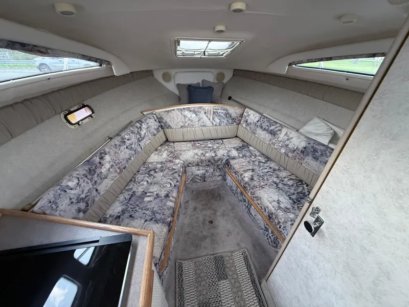 Slide: The Image of Interior of 1997 Bayliner 2655 Ciera boat with cushioned seating and skylight. - 6