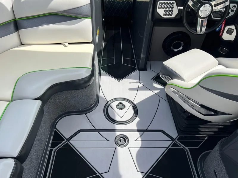Slide: The Image of Interior of a 2014 Supra SA450 boat with stylish seating and modern dashboard. - 11