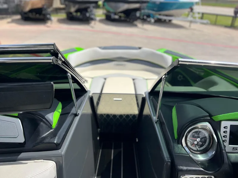 Slide: The Image of 2014 Supra SA450 boat interior with green accents and dashboard view. - 12