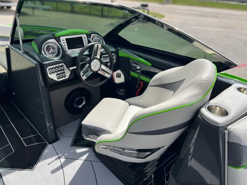 Slide: The Image of Interior of a 2014 Supra SA450 boat with modern dashboard and steering wheel. - 14