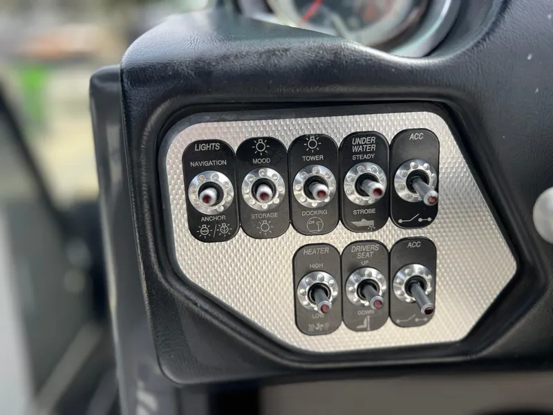 Slide: The Image of Control panel of a 2014 Supra SA450 boat with various switches and labels. - 15