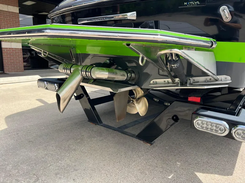 Slide: The Image of Rear view of a 2014 Supra SA450 boat with visible propeller and exhaust system. - 20