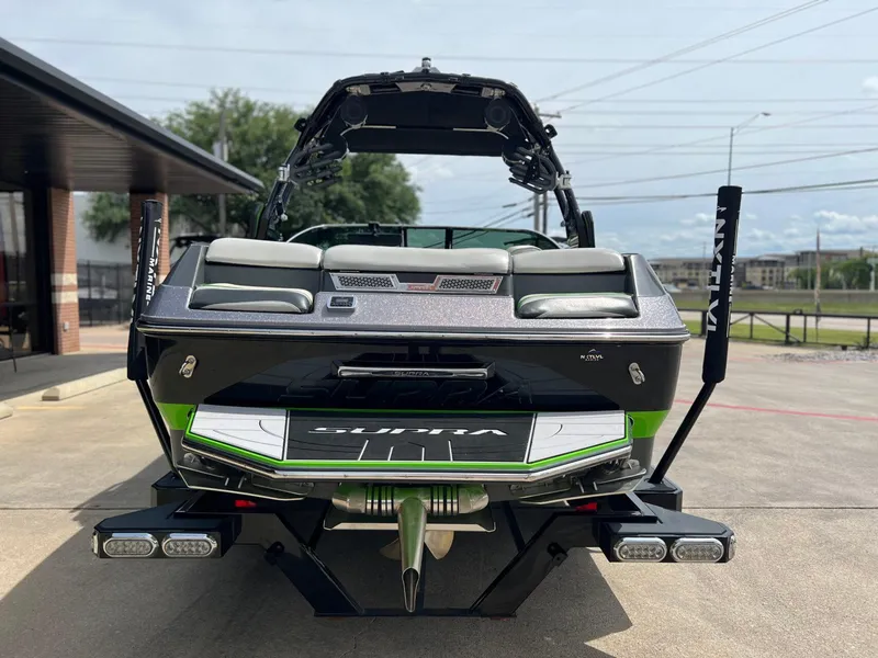 Slide: The Image of 2014 Supra SA450 boat, rear view, parked outdoors on a sunny day. - 21