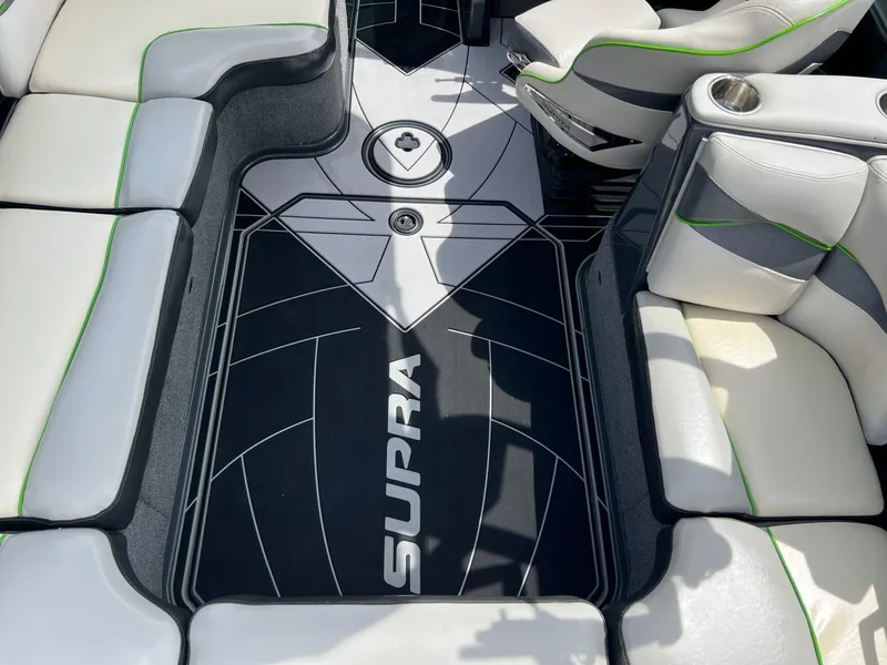 Slide: The Image of Interior of 2014 Supra SA450 boat with stylish seating and branded flooring. - 7