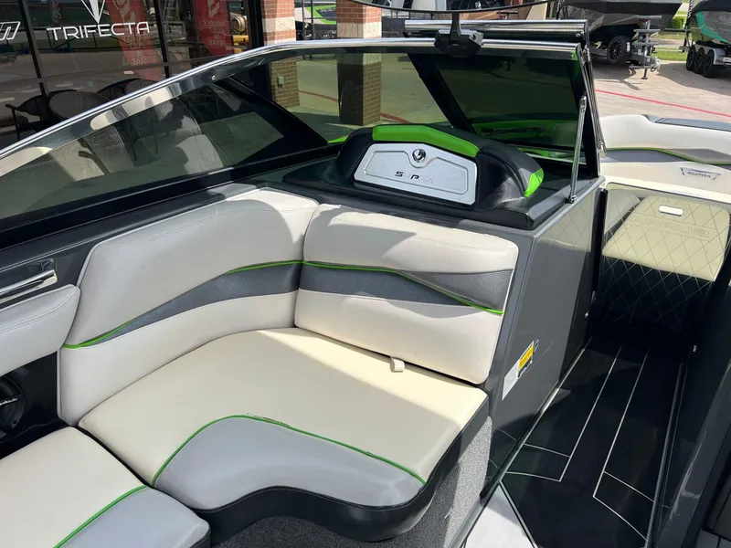 Slide: The Image of 2014 Supra SA450 boat interior with modern seating and green accents. - 9