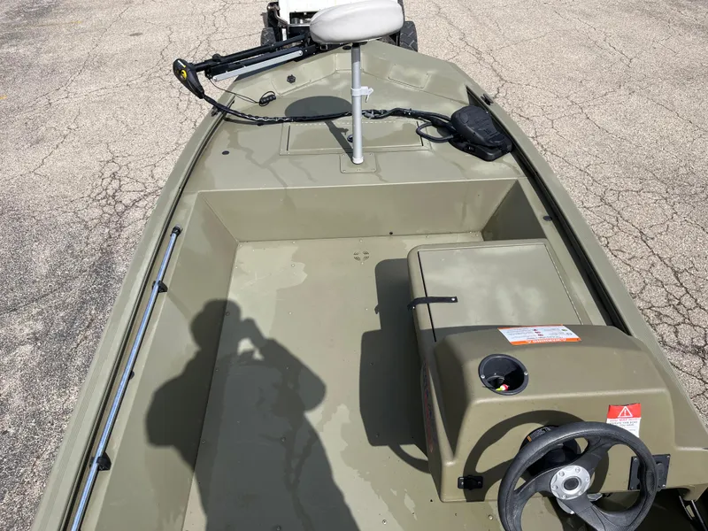 Slide: The Image of 2022 Tracker Grizzly 1648 SC boat interior with steering wheel and seat. - 2