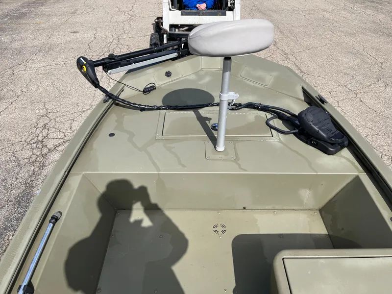 Slide: The Image of 2022 Tracker Grizzly 1648 SC boat interior with seat and steering controls. - 4