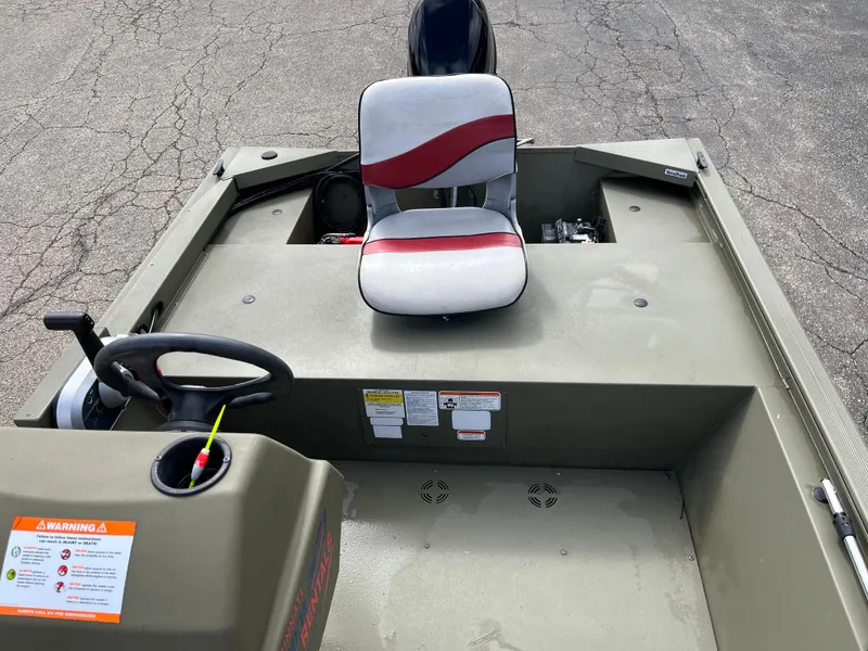 Slide: The Image of 2022 Tracker Grizzly 1648 SC boat interior with steering wheel and seat. - 5