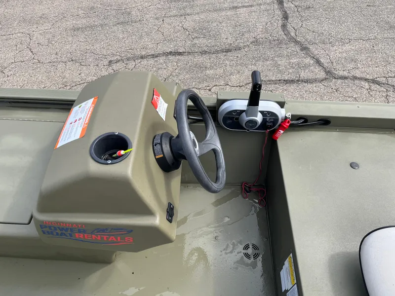Slide: The Image of 2022 Tracker Grizzly 1648 SC boat console with steering wheel and controls. - 6