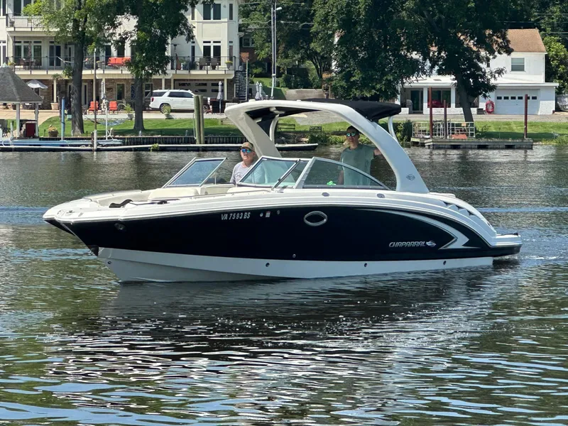 The Image of 2008 Chaparral Sunesta 284 boat on a calm lake near waterfront homes. - 0