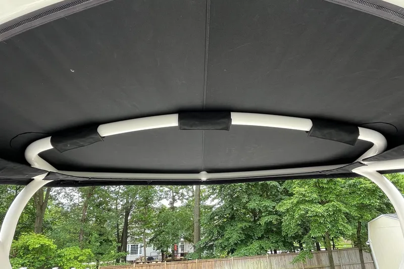 Slide: The Image of 2009 Chaparral Sunesta 284 boat canopy with trees in the background. - 11