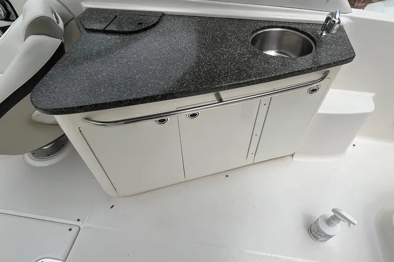 Slide: The Image of 2009 Chaparral Sunesta 284 boat interior with sink and countertop. - 12