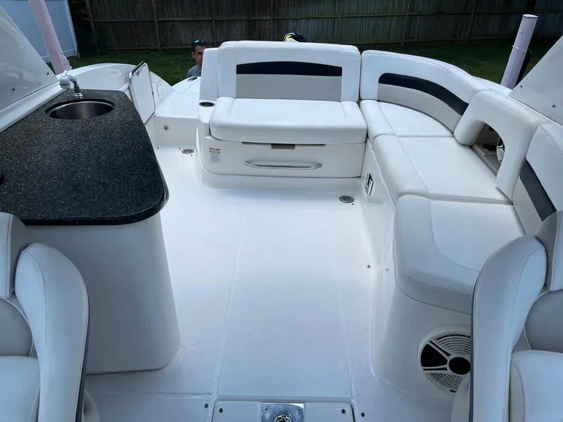 Slide: The Image of 2008 Chaparral Sunesta 284 boat interior with white seating and a small sink. - 17