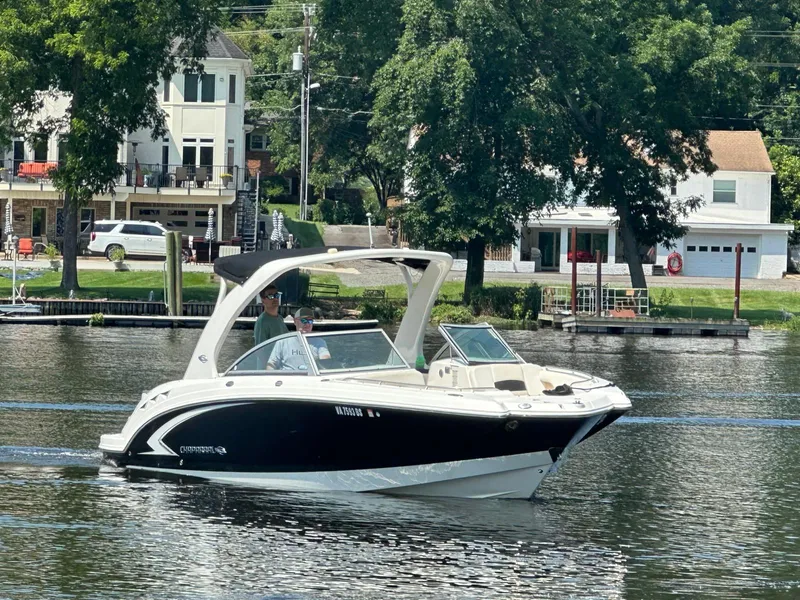 Slide: The Image of 2008 Chaparral Sunesta 284 boat cruising on a calm river near waterfront homes. - 3