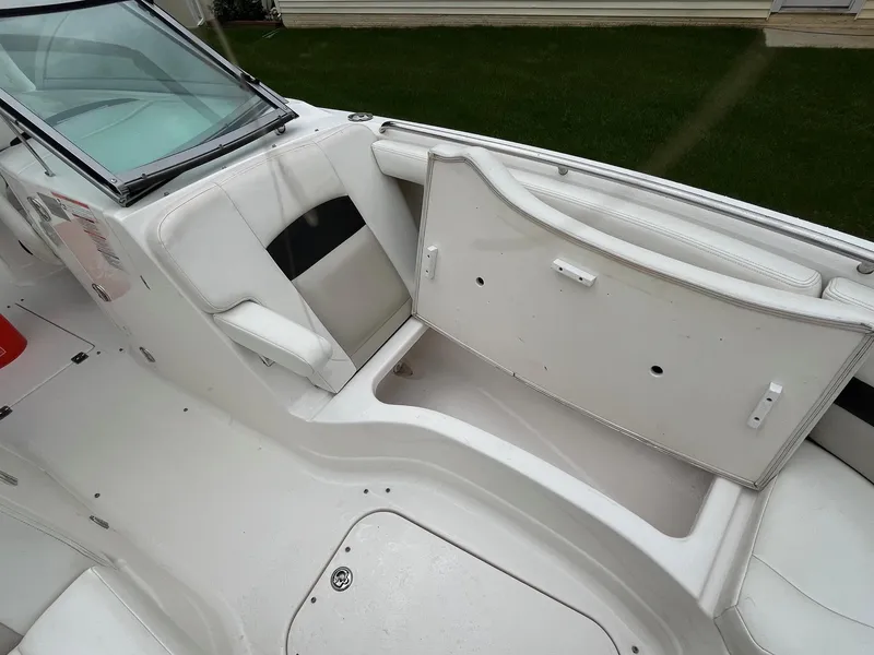 Slide: The Image of 2009 Chaparral Sunesta 284 boat interior with open storage compartment and seating. - 9