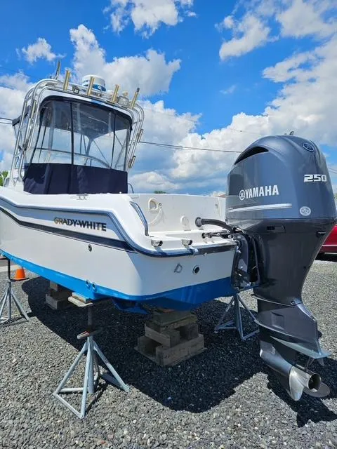 Slide: The Image of 1999 Grady-White Voyager 248 boat with Yamaha 250 engine, displayed outdoors on stands. - 3