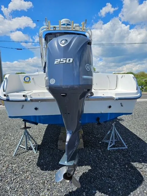 Slide: The Image of 1999 Grady-White Voyager 248 boat with Yamaha 250 outboard motor, displayed on stands. - 6