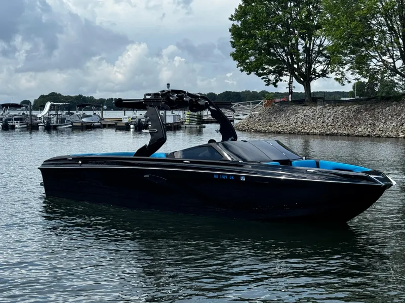 Slide: The Image of 2019 Centurion Ri257 boat on a calm lake with cloudy skies. - 1