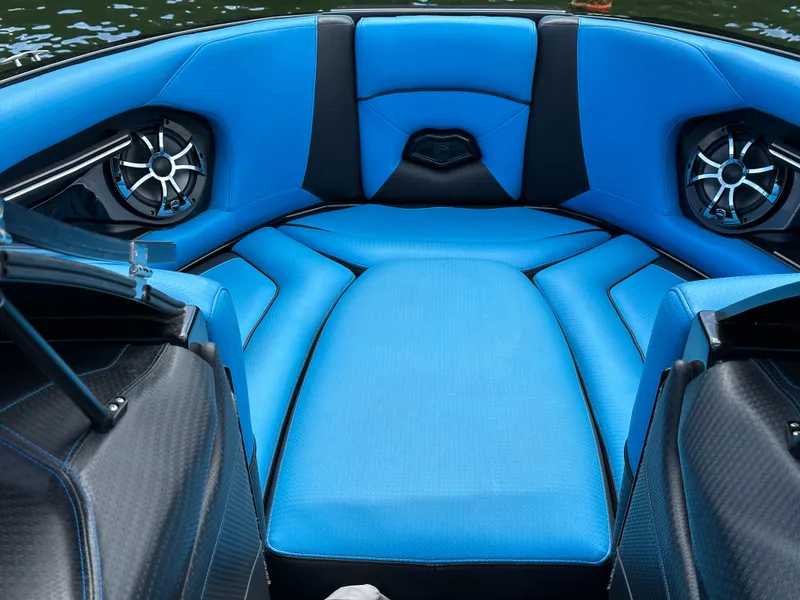 Slide: The Image of 2019 Centurion Ri257 boat interior with blue seating and speakers. - 11