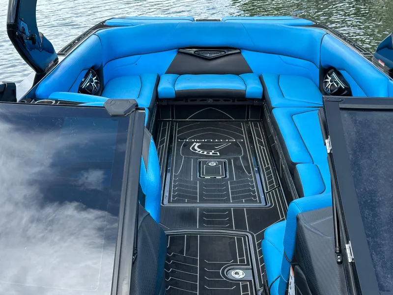 Slide: The Image of 2019 Centurion Ri257 boat interior with blue seating and sleek design. - 13