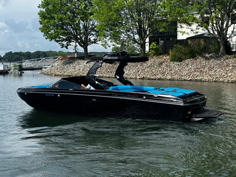 Slide: The Image of 2019 Centurion Ri257 boat on a calm lake with trees in the background. - 3