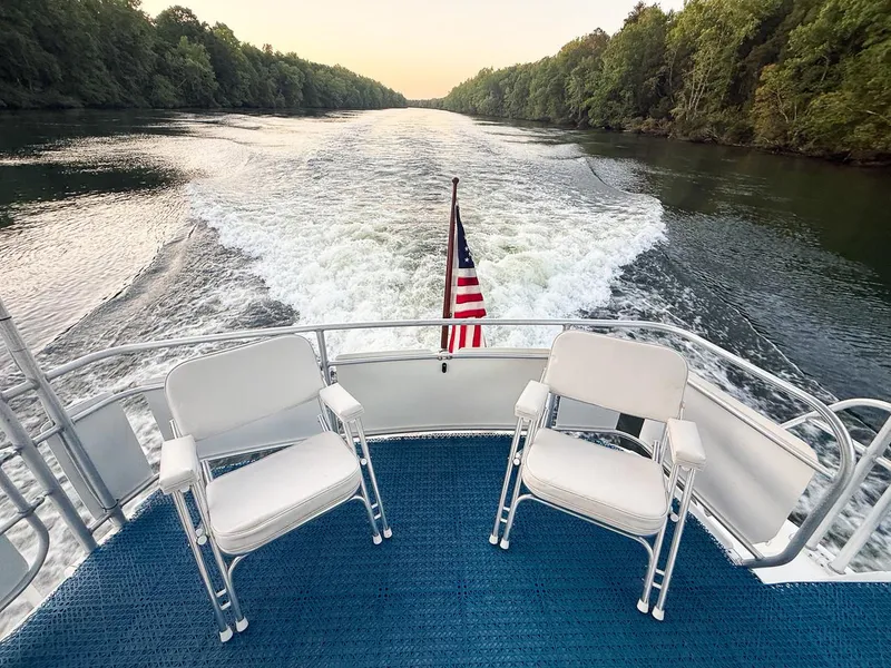 Slide: The Image of Aft view from 1996 Mainship 37 Aft Cabin boat cruising on a serene river. - 11