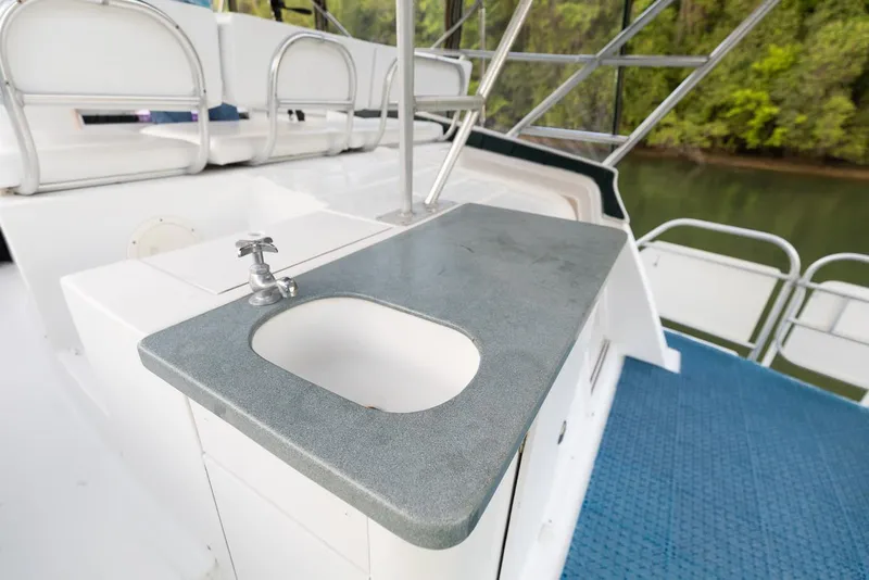 Slide: The Image of 1996 Mainship 37 Aft Cabin yacht with outdoor sink and seating area. - 12