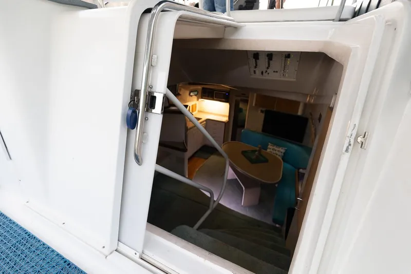 Slide: The Image of Interior view of 1996 Mainship 37 Aft Cabin, showing cozy seating and table area. - 14