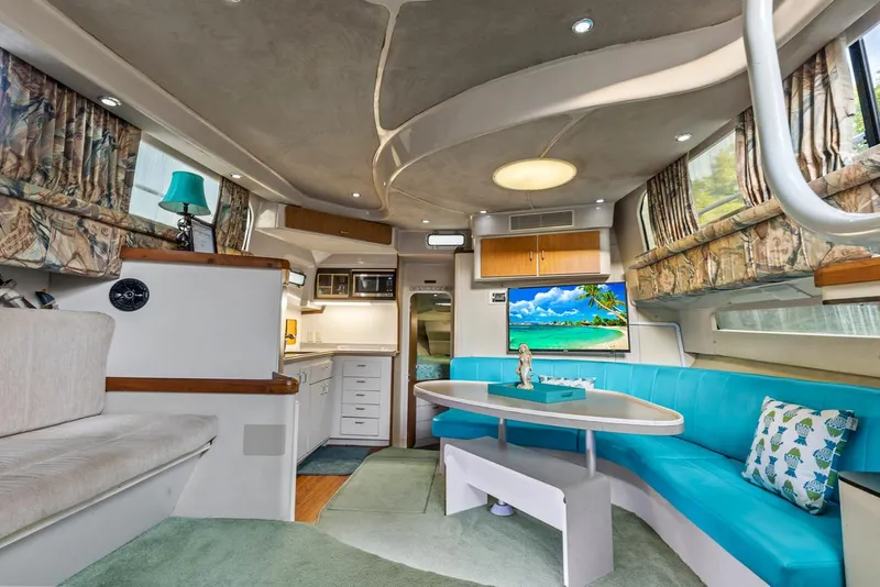 Slide: The Image of Interior of a 1996 Mainship 37 Aft Cabin yacht with modern amenities and vibrant decor. - 19