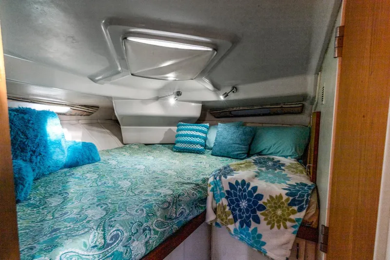 Slide: The Image of Cozy cabin interior of 1996 Mainship 37 Aft Cabin with vibrant bedding and pillows. - 25