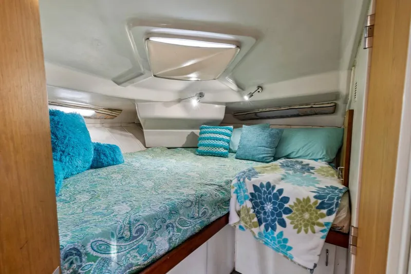 Slide: The Image of 1996 Mainship 37 Aft Cabin interior with cozy bed and colorful pillows. - 26