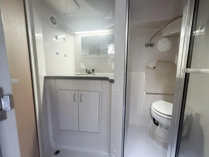 Slide: The Image of 1996 Mainship 37 Aft Cabin bathroom with shower, sink, and toilet. - 27