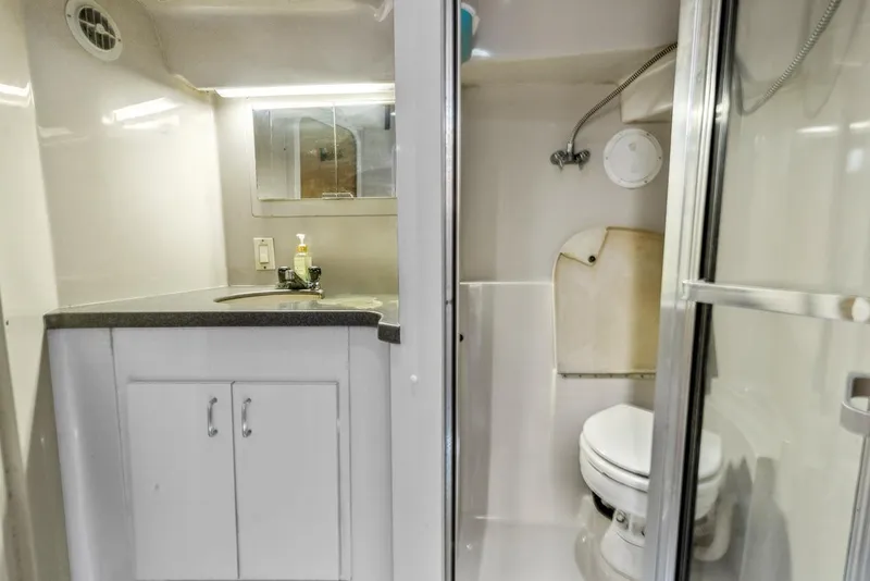 Slide: The Image of 1996 Mainship 37 Aft Cabin bathroom with shower, sink, and toilet. - 28