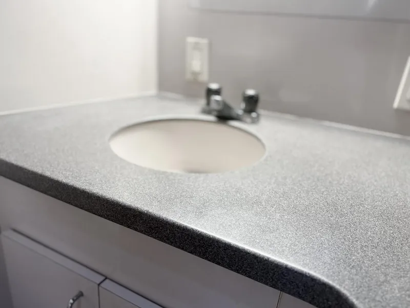 Slide: The Image of Gray countertop with sink in 1996 Mainship 37 Aft Cabin yacht bathroom. - 34