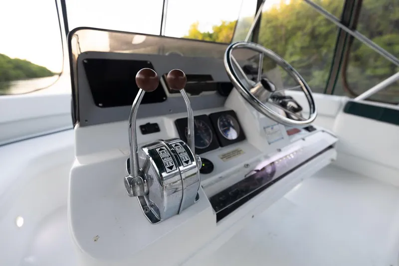 Slide: The Image of 1996 Mainship 37 Aft Cabin helm with steering wheel and controls. - 6
