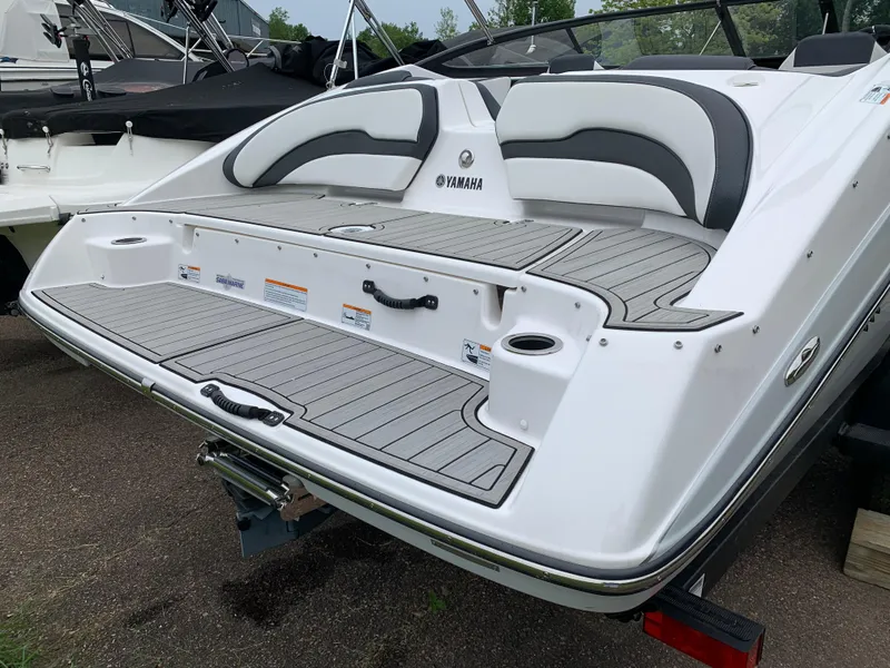 Slide: The Image of 2023 Yamaha Boats SX195 rear view, featuring sleek design and spacious swim platform. - 15