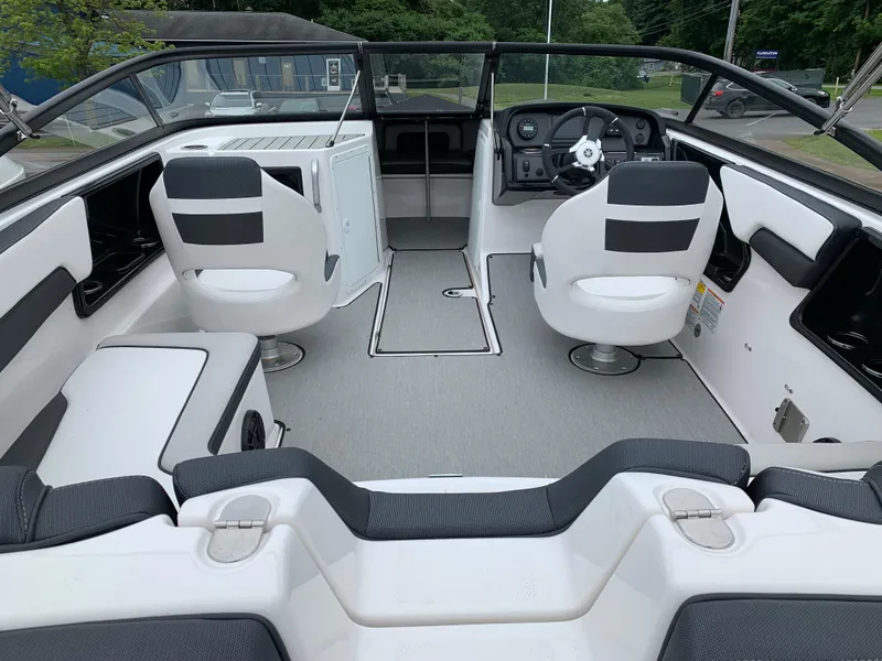 Slide: The Image of 2023 Yamaha Boats SX195 interior with sleek seating and modern dashboard design. - 17
