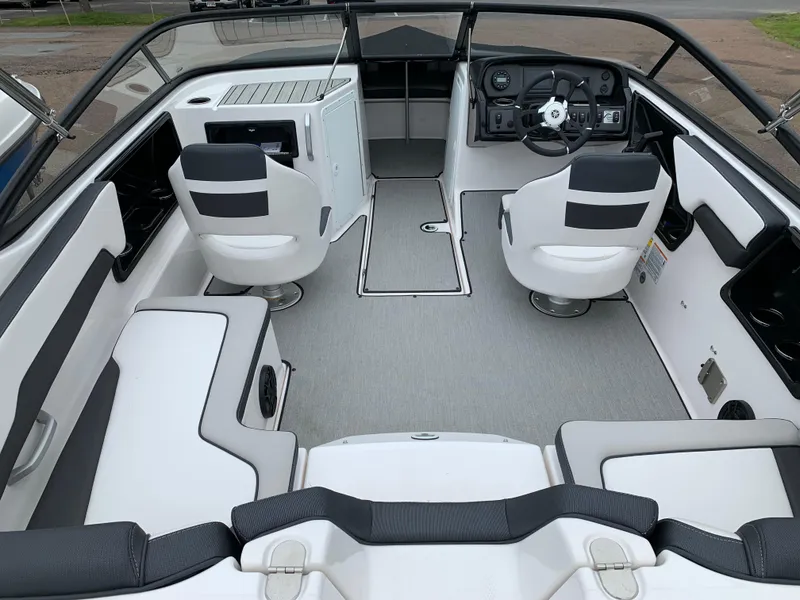 Slide: The Image of 2023 Yamaha Boats SX195 interior with modern seating and sleek dashboard design. - 18