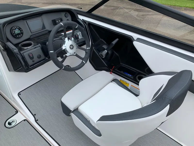 Slide: The Image of 2023 Yamaha Boats SX195 cockpit with steering wheel and control panel. - 19