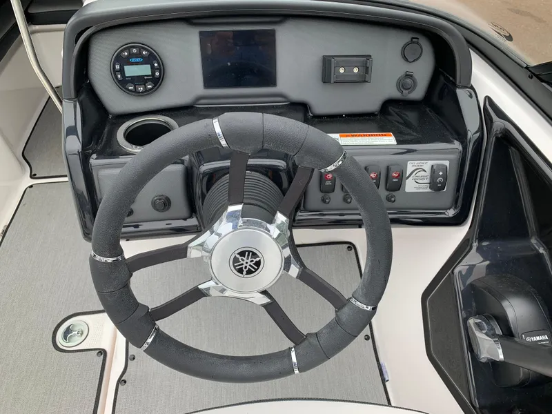 Slide: The Image of 2023 Yamaha SX195 boat dashboard with steering wheel and control panel. - 20