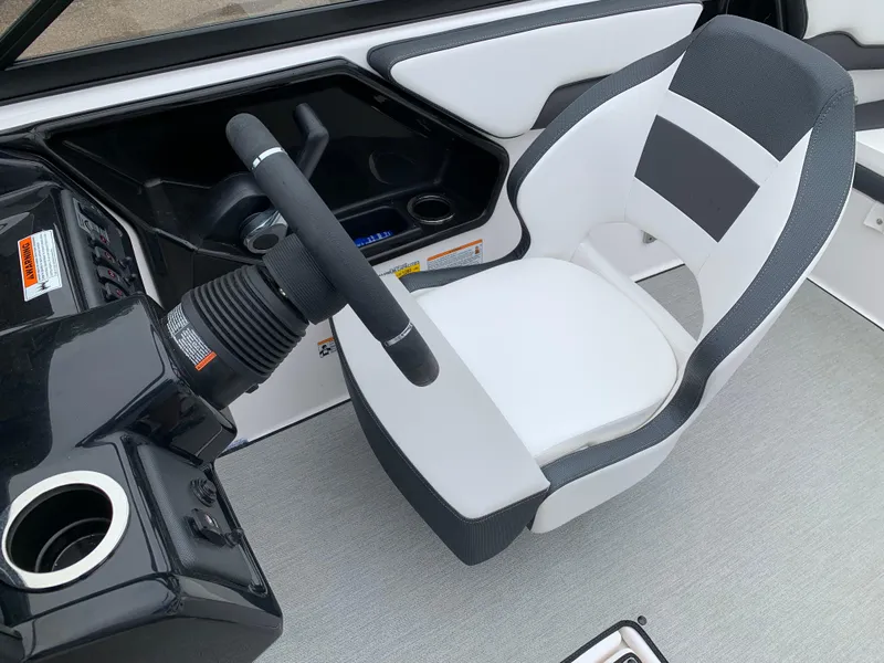 Slide: The Image of 2023 Yamaha Boats SX195 interior with steering wheel and captain's chair. - 23