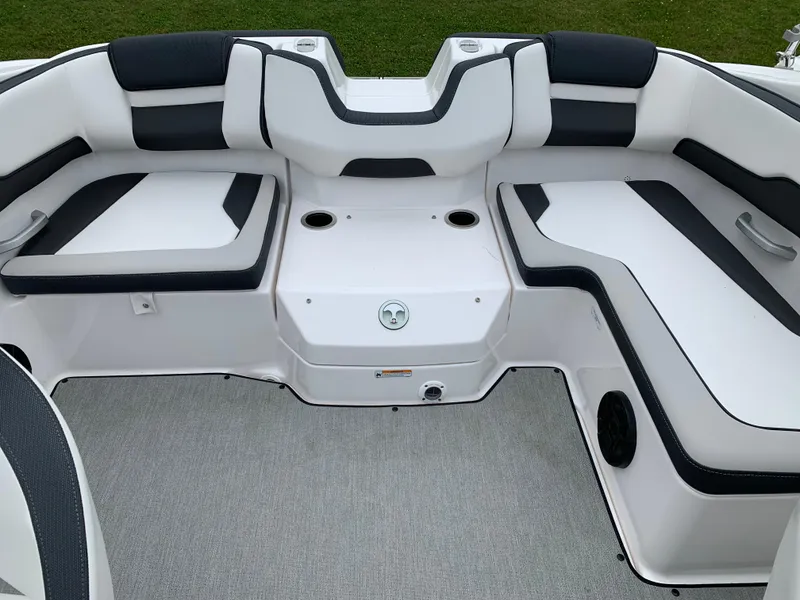Slide: The Image of 2023 Yamaha Boats SX195 interior seating with white and black upholstery. - 25