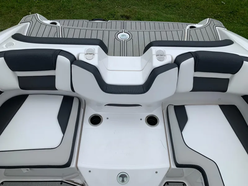 Slide: The Image of 2023 Yamaha Boats SX195 interior seating with sleek design and cup holders. - 27