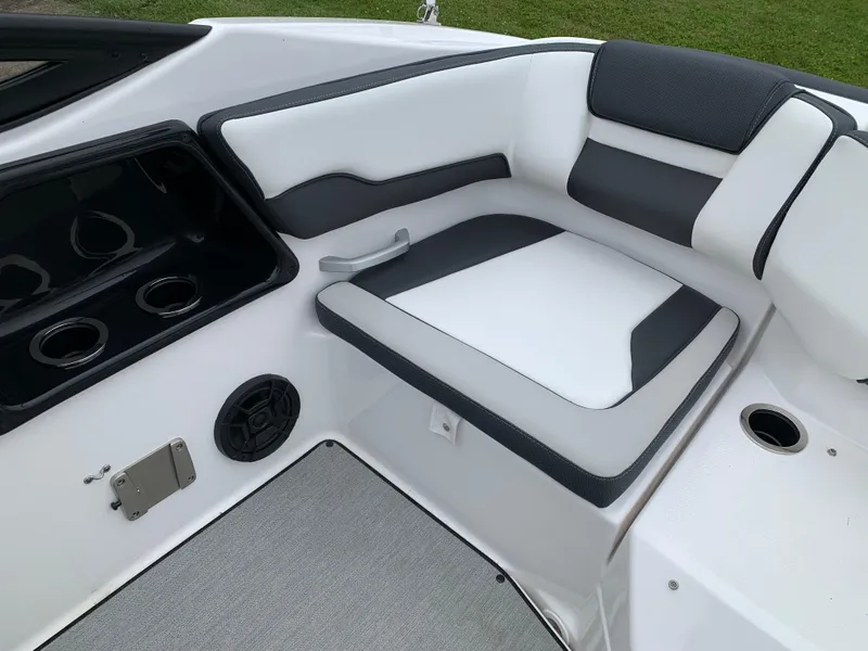 Slide: The Image of 2023 Yamaha SX195 boat interior with cushioned seating and cup holders. - 28